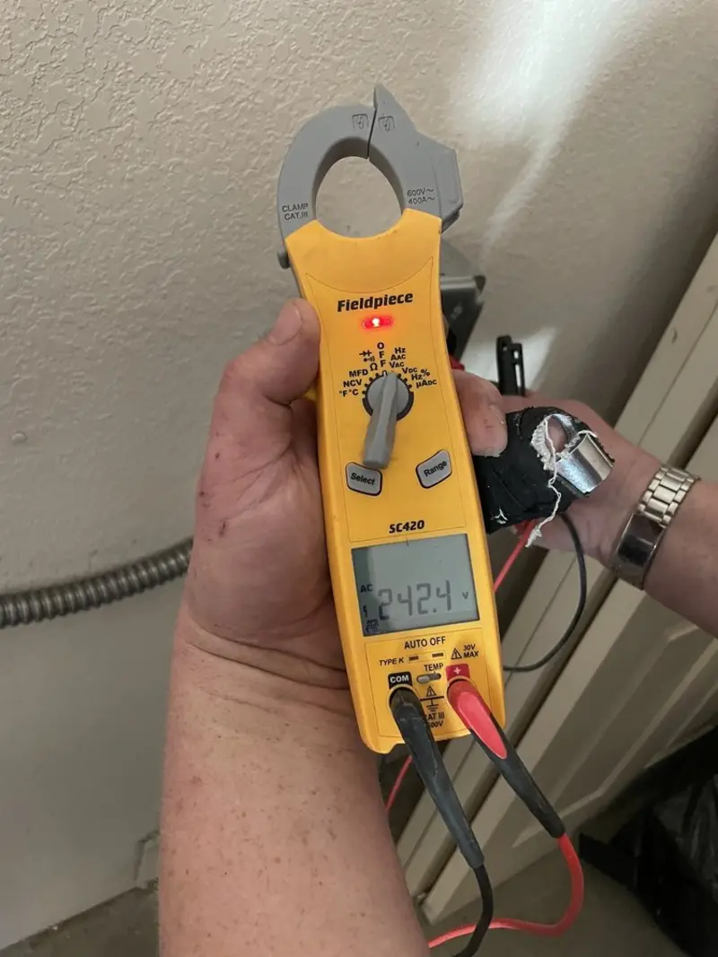 Voltage testing with clamp meter during Outlet Installation in Bear